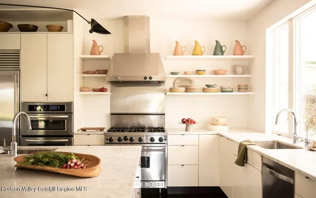 a kitchen with a stove a refrigerator and a sink