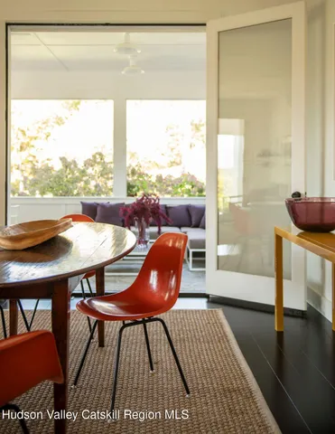 a living room with a table and a large window