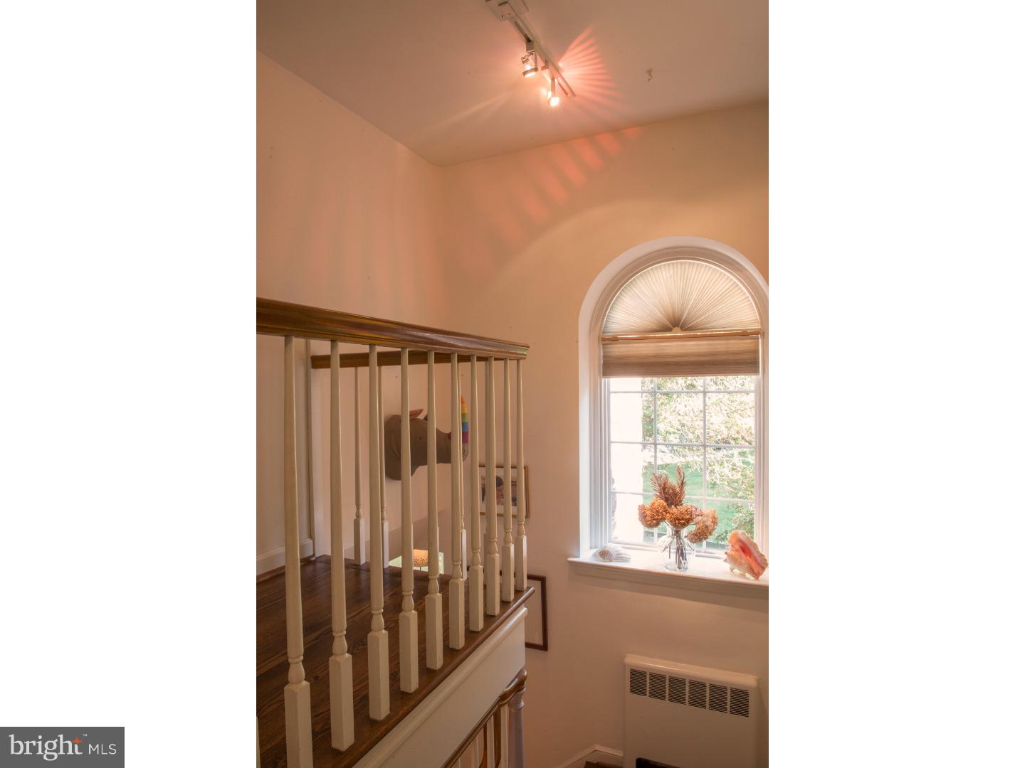 212 North Bent Road Wyncote, PA 19095 - Photo 18 of 25 a view of a hallway with wooden floor and a living room