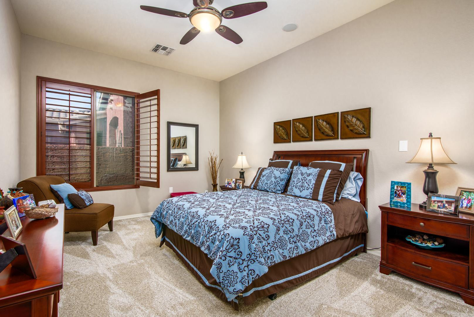 42204 West Rummy Road Maricopa, AZ 85138 - Photo 29 of 79 a bedroom with a bed and a chandelier