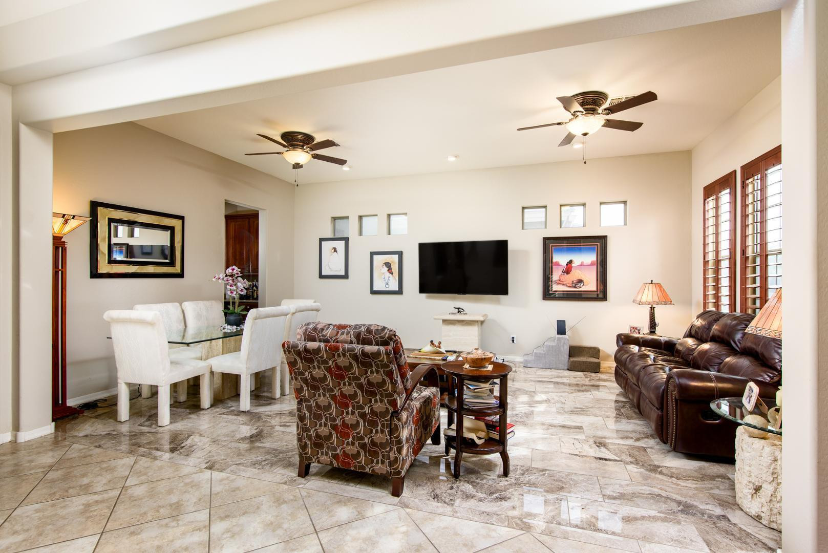 42204 West Rummy Road Maricopa, AZ 85138 - Photo 8 of 79 a living room with furniture a flat screen tv and kitchen view