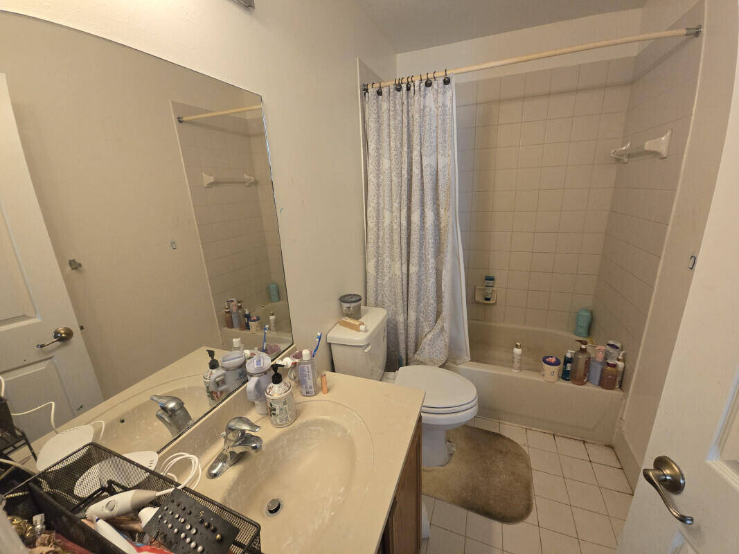 6511 Sandy Bank Terrace Riviera Beach, FL 33407 - Photo 10 of 12 a bathroom with a bathtub shower sink and toilet