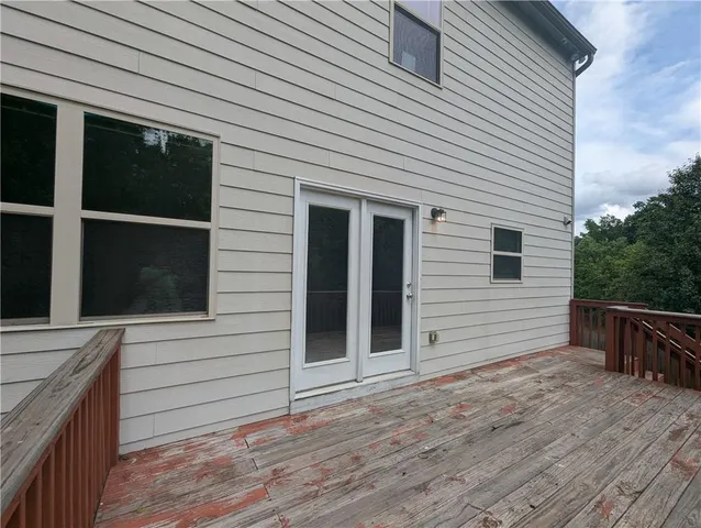 a view of a house with a wooden deck