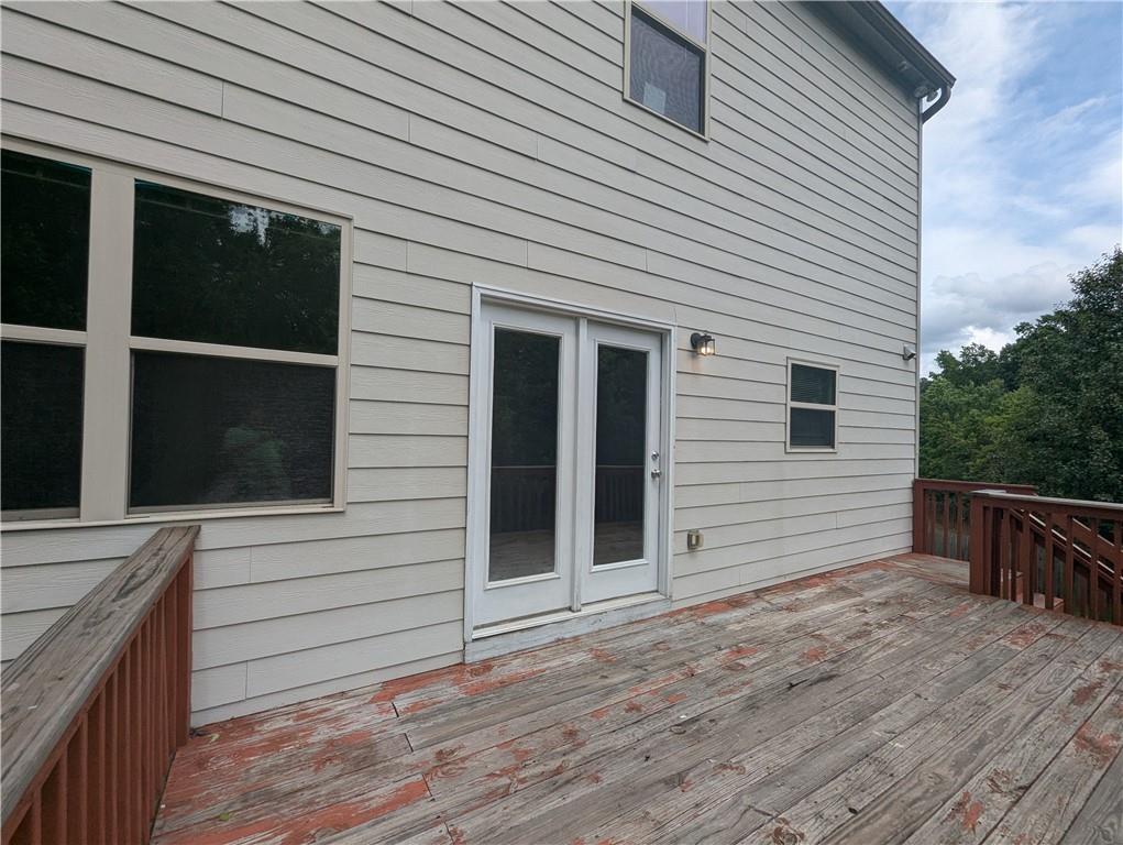 355 Fowler Springs Court Alpharetta, GA 30004 - Photo 14 of 16 a view of a house with a wooden deck