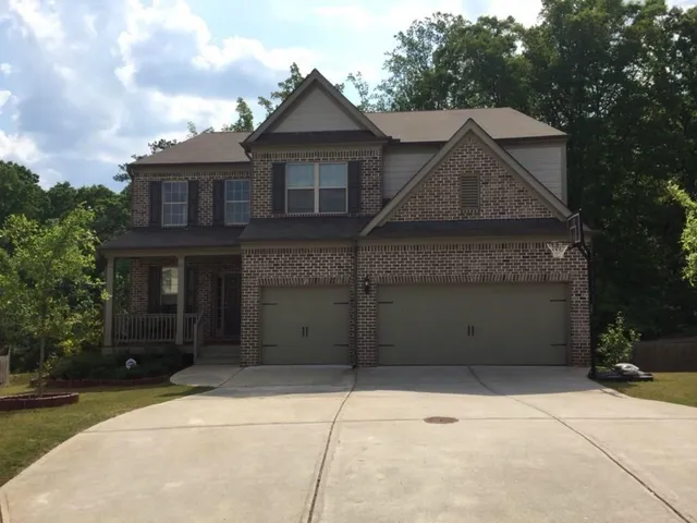 a front view of a house with a yard and garage