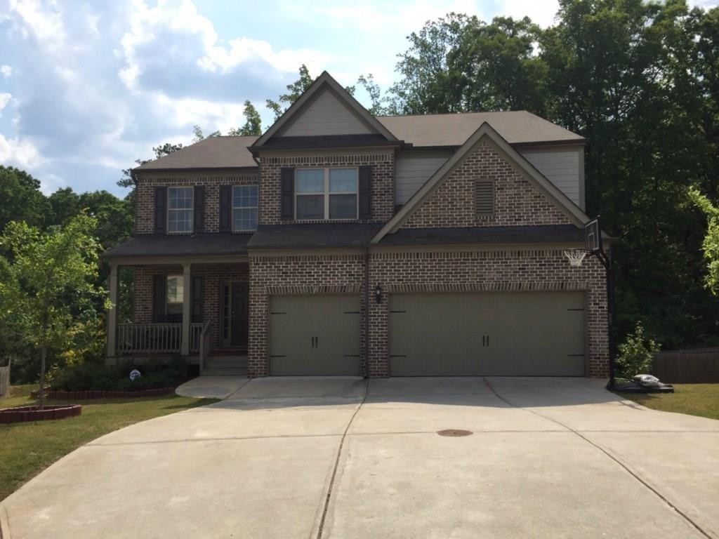 355 Fowler Springs Court Alpharetta, GA 30004 - Photo 16 of 16 a front view of a house with a yard and garage