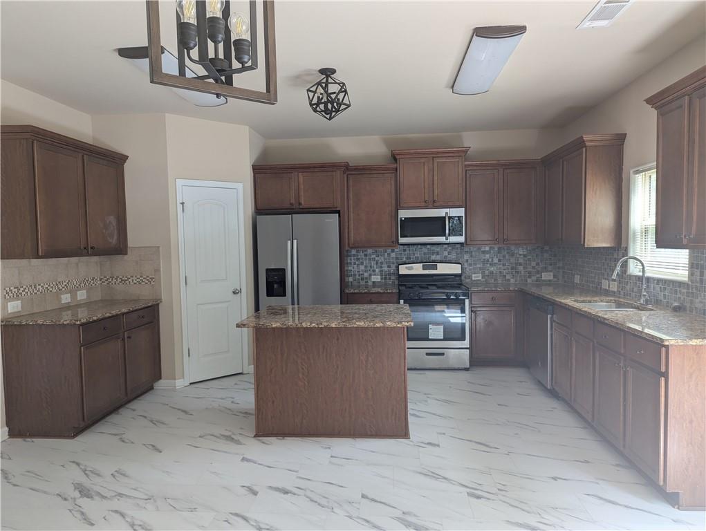 355 Fowler Springs Court Alpharetta, GA 30004 - Photo 2 of 16 a open kitchen with stainless steel appliances granite countertop a stove top oven a sink a counter top space and cabinets