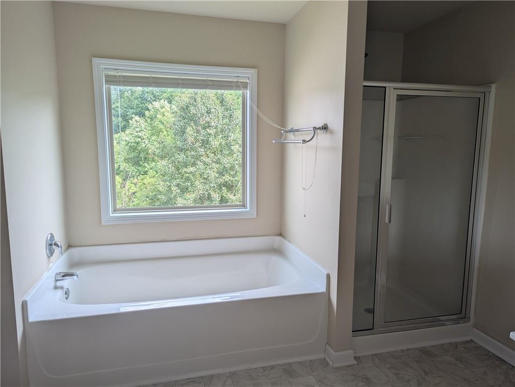 355 Fowler Springs Court Alpharetta, GA 30004 - Photo 7 of 16 a white bath tub sitting in a bathroom next to a window