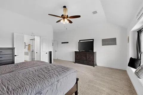 a bedroom with a bed and a flat screen tv