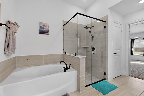 a white bath tub sitting next to a shower