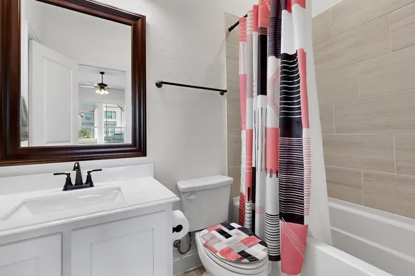 a bathroom with a sink toilet and shower
