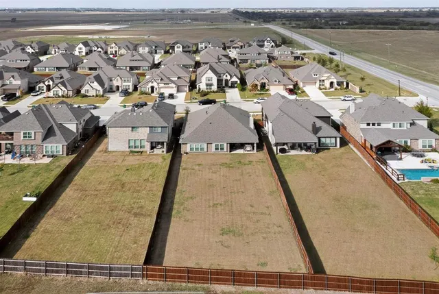an aerial view of residential houses with outdoor space