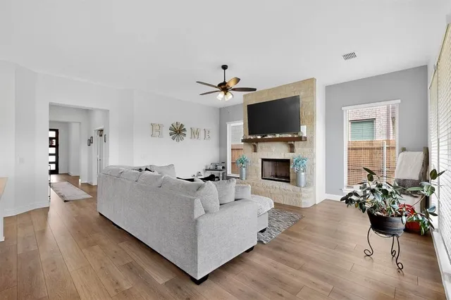 a living room with furniture a flat screen tv and a fireplace