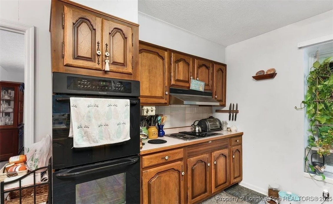 744 Azalea Drive Vass, NC 28394 - Photo 11 of 16 a kitchen with stainless steel appliances granite countertop a stove a sink and a microwave