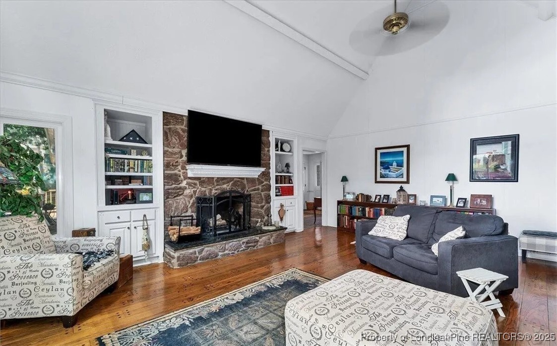 744 Azalea Drive Vass, NC 28394 - Photo 15 of 16 a living room with furniture a fireplace and a flat screen tv