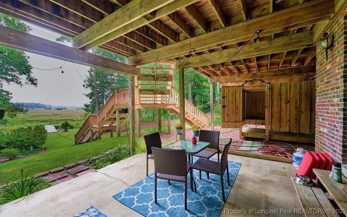 744 Azalea Drive Vass, NC 28394 - Photo 6 of 16 a view of a porch with furniture and a yard