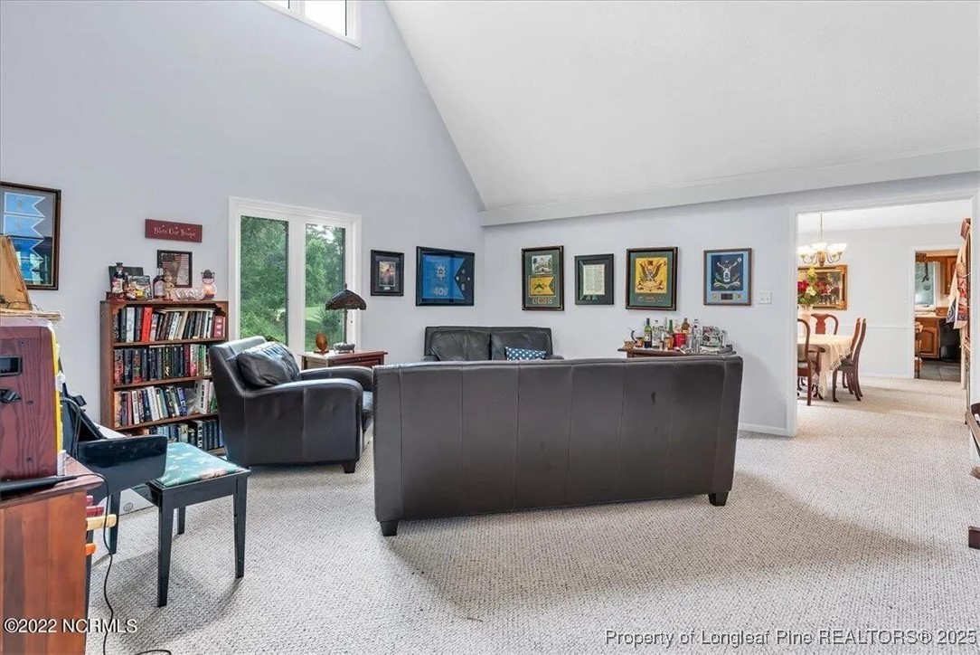 744 Azalea Drive Vass, NC 28394 - Photo 9 of 16 a living room with furniture and a flat screen tv