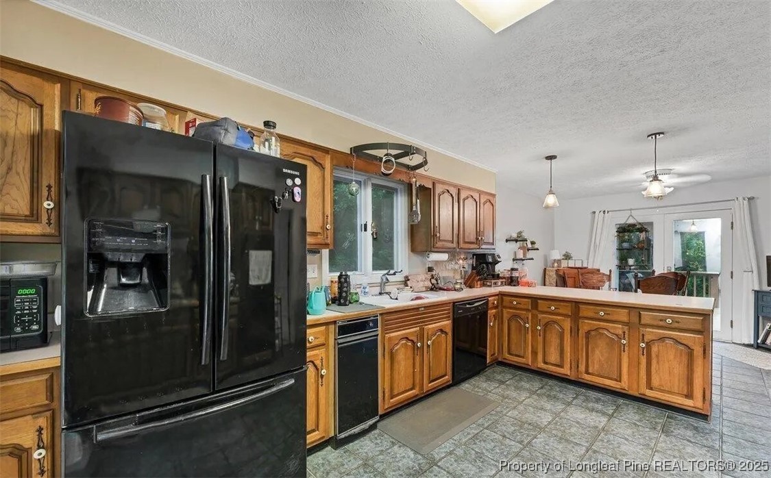 744 Azalea Drive Vass, NC 28394 - Photo 10 of 16 a large kitchen with a sink and dishwasher a stove top oven with wooden floor