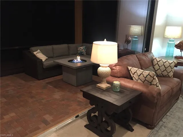 a living room with furniture and a lamp