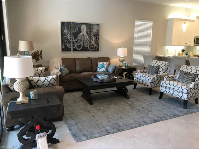 a living room with furniture and a lamp