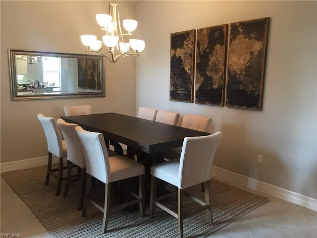 a view of a dining room with furniture and chandelier