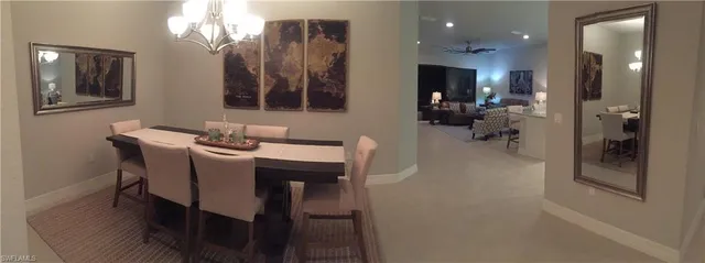 a view of a dining room with furniture and a chandelier