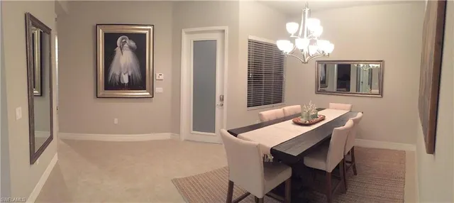 a view of a dining room with furniture and chandelier