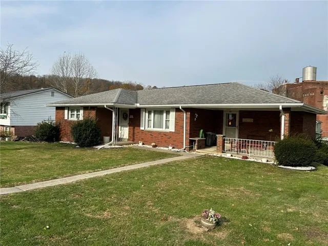 a front view of a house with a garden and porch