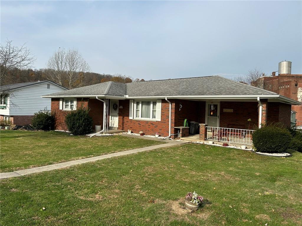 356 3rd Street Smithton, PA 15479 - Photo 12 of 15 a front view of a house with a garden and porch