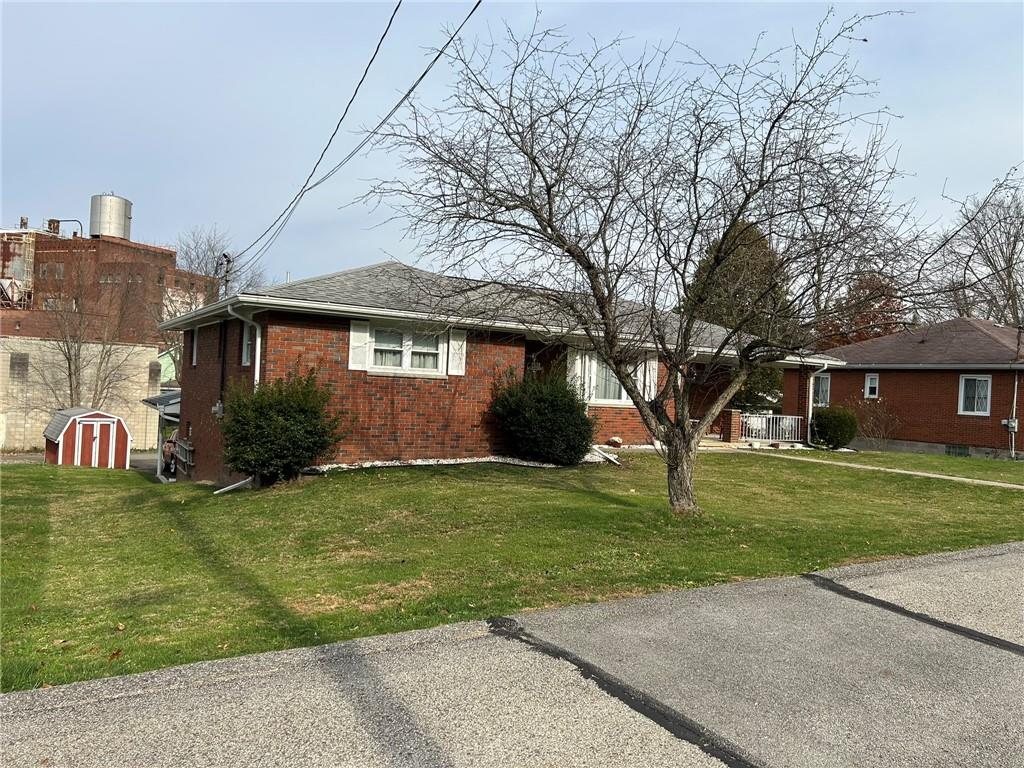 356 3rd Street Smithton, PA 15479 - Photo 13 of 15 a front view of a house with a garden and trees