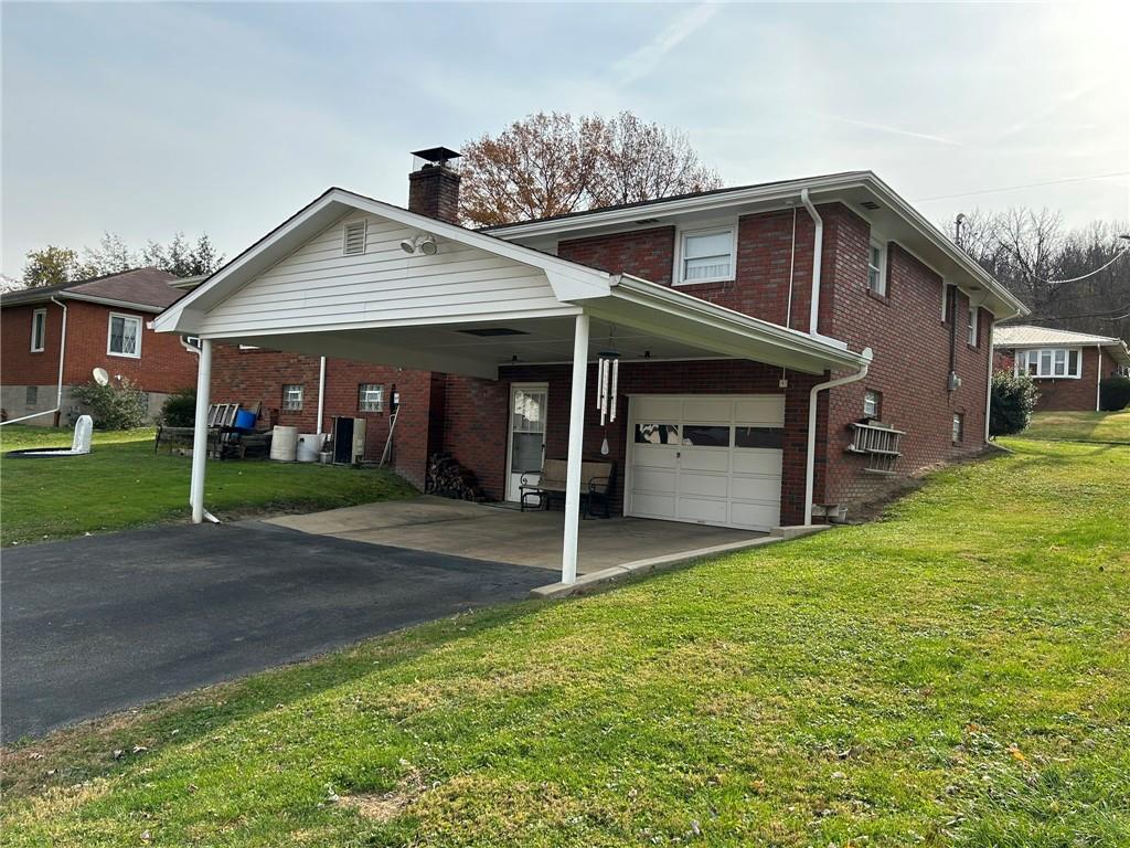 356 3rd Street Smithton, PA 15479 - Photo 14 of 15 a view of a house with a yard and garage