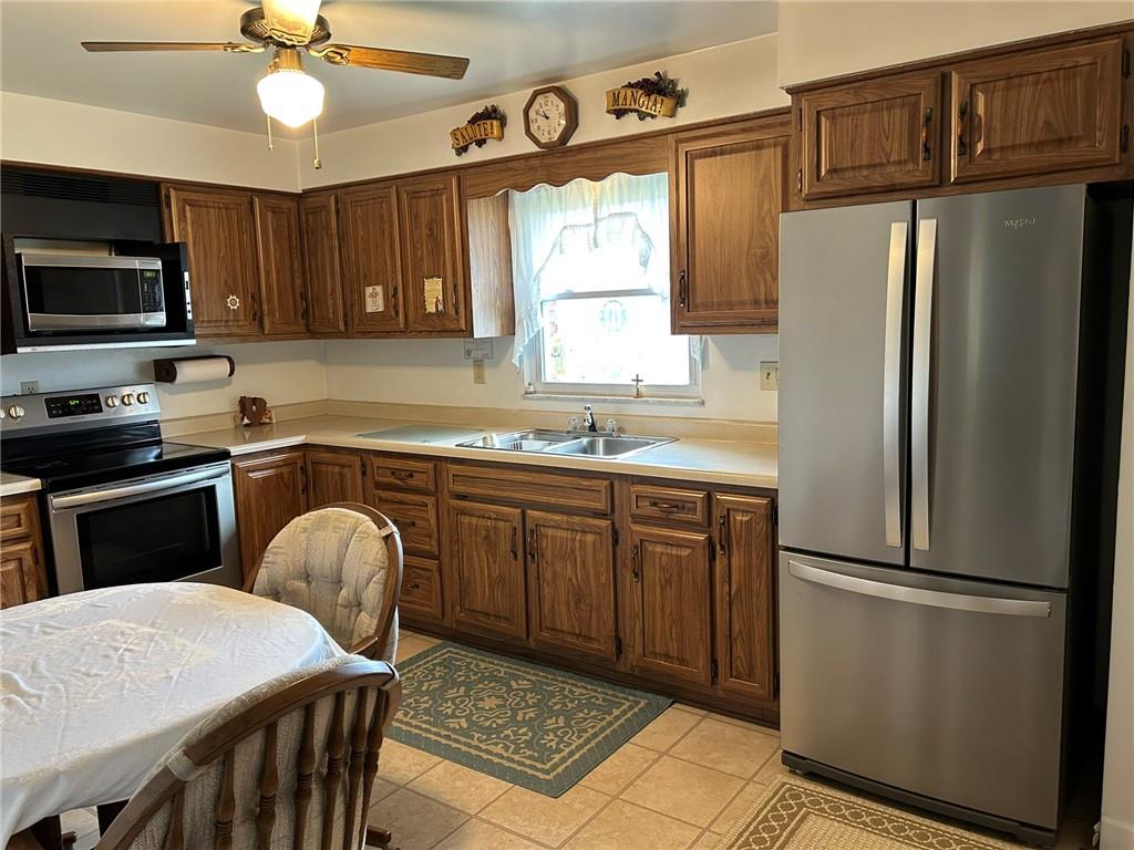 356 3rd Street Smithton, PA 15479 - Photo 2 of 15 a kitchen with stainless steel appliances granite countertop a refrigerator a stove a sink a microwave and island