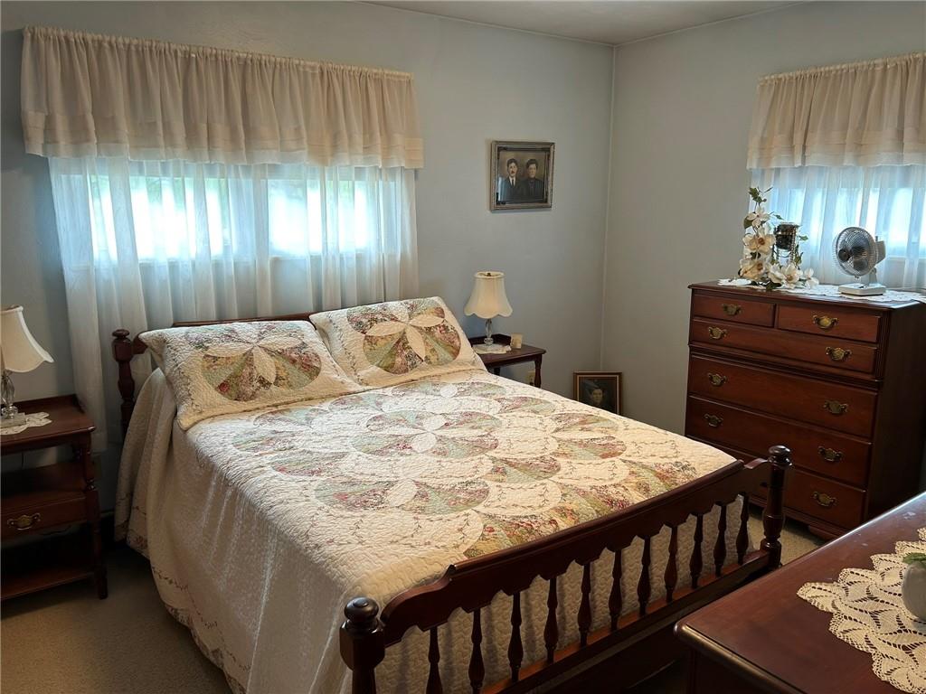 356 3rd Street Smithton, PA 15479 - Photo 9 of 15 a bedroom with a bed and wooden floor