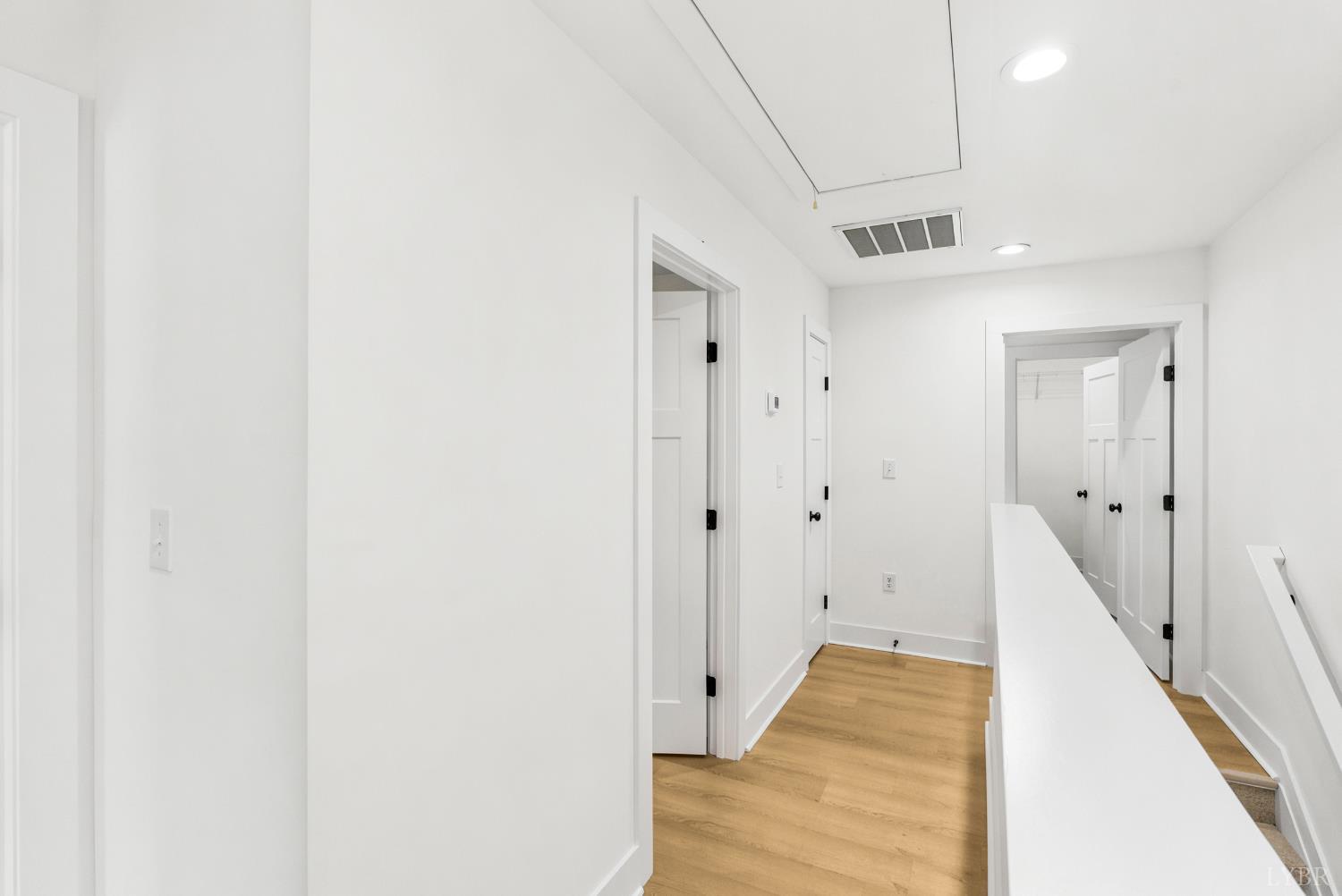 556 Leesville Road, Unit 406 Lynchburg, VA 24502 - Photo 20 of 39 a view of a hallway with wooden floor and staircase