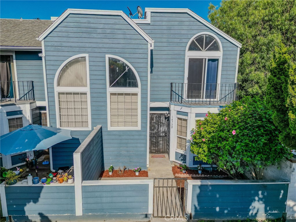 14738 Pioneer Boulevard Norwalk, CA 90650 - Photo 19 of 72 a front view of a house with a porch