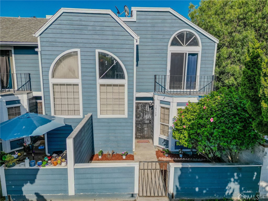 14738 Pioneer Boulevard Norwalk, CA 90650 - Photo 20 of 72 a front view of a house with a garden