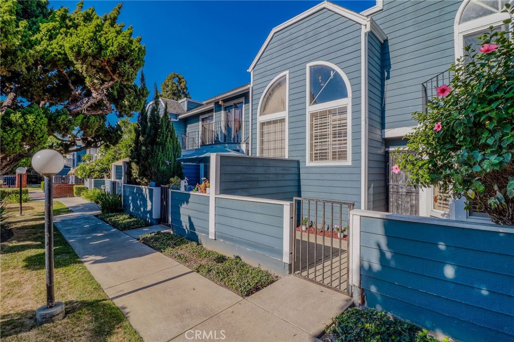14738 Pioneer Boulevard Norwalk, CA 90650 - Photo 2 of 72 a front view of a house with a garden