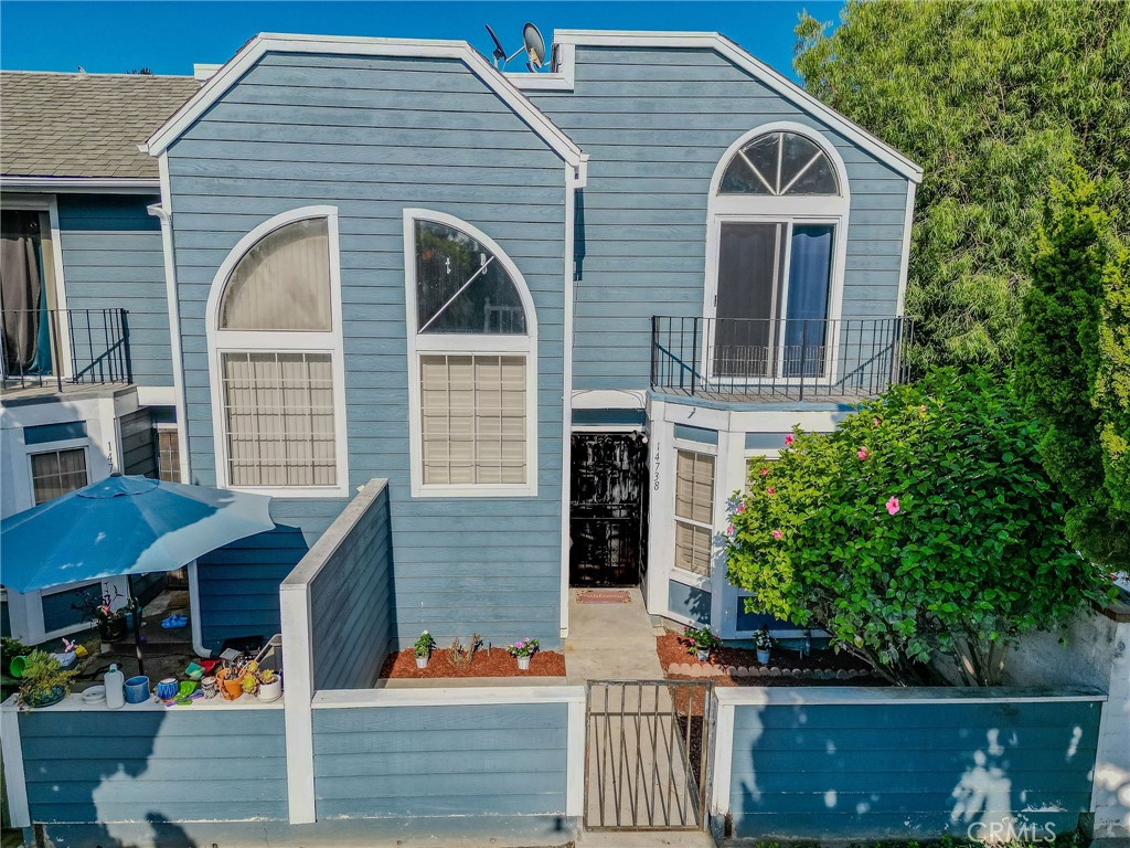 14738 Pioneer Boulevard Norwalk, CA 90650 - Photo 21 of 72 a front view of a house with a garden