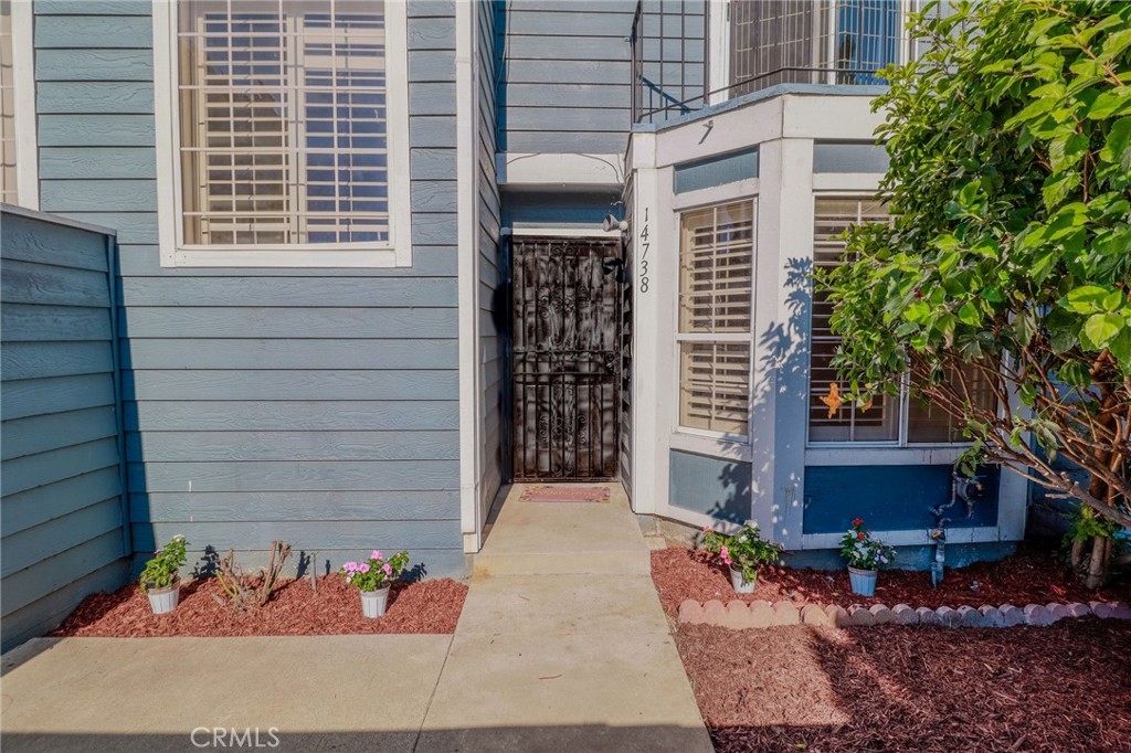 14738 Pioneer Boulevard Norwalk, CA 90650 - Photo 34 of 72 a couple of potted plants in front of door