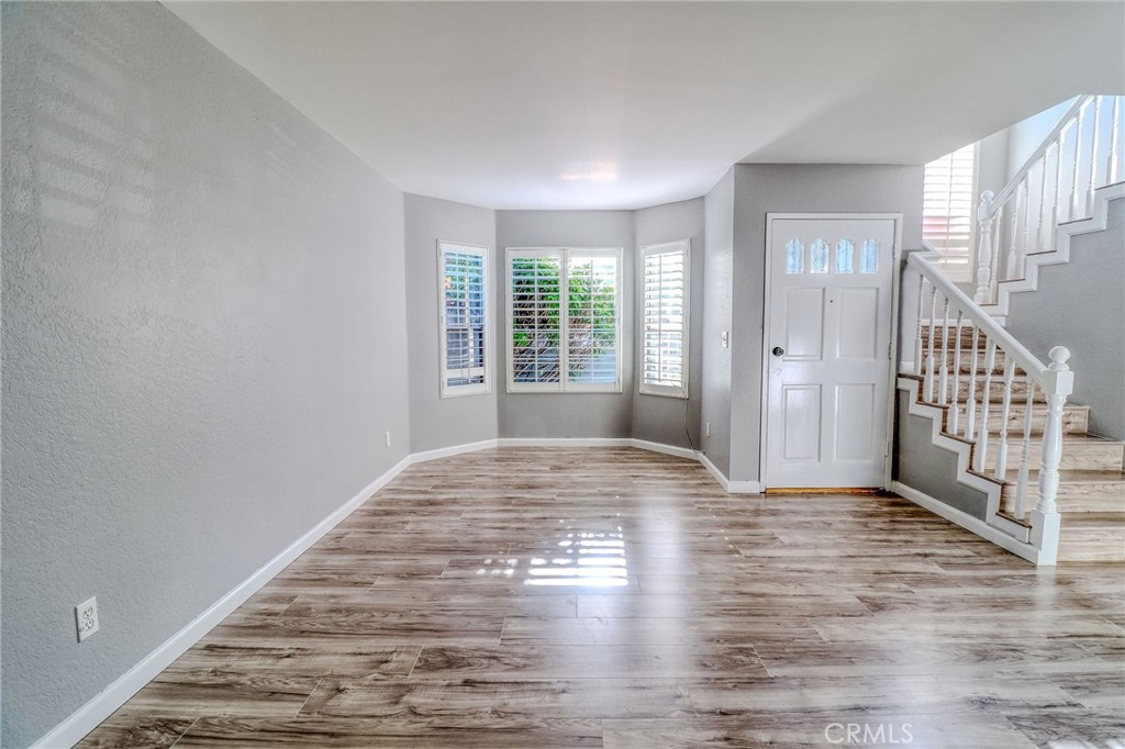 14738 Pioneer Boulevard Norwalk, CA 90650 - Photo 43 of 72 a view of an empty room with wooden floor and a window