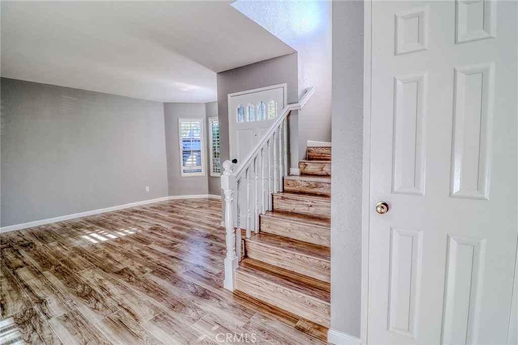 14738 Pioneer Boulevard Norwalk, CA 90650 - Photo 47 of 72 a view of a hallway with wooden floor and entryway