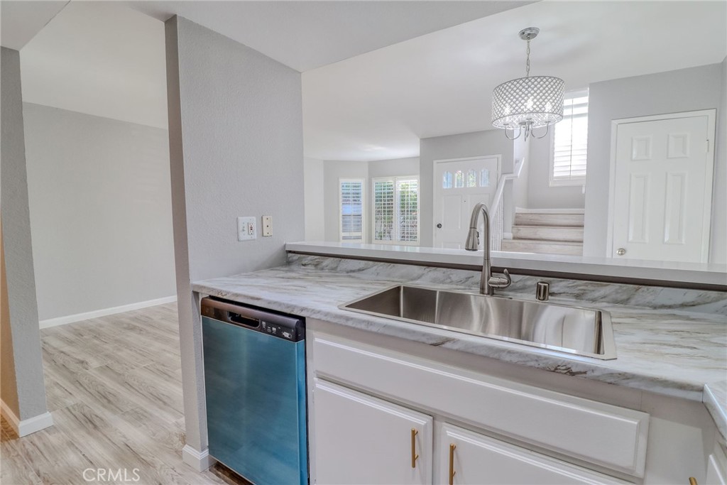 14738 Pioneer Boulevard Norwalk, CA 90650 - Photo 50 of 72 a kitchen with a sink and chandelier