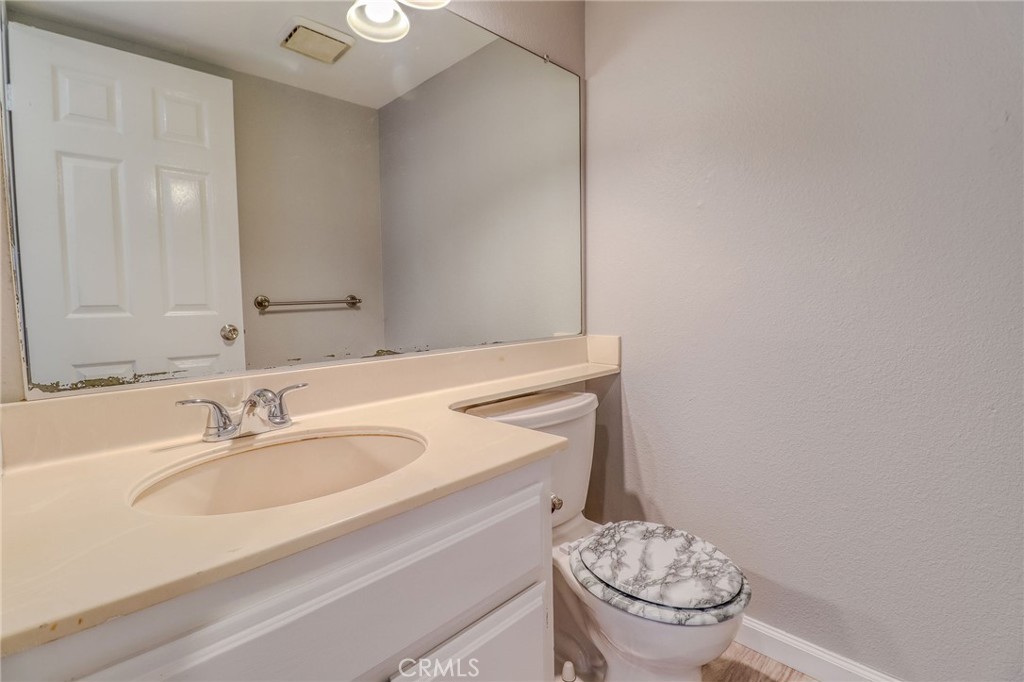 14738 Pioneer Boulevard Norwalk, CA 90650 - Photo 53 of 72 a bathroom with a sink a toilet and a mirror