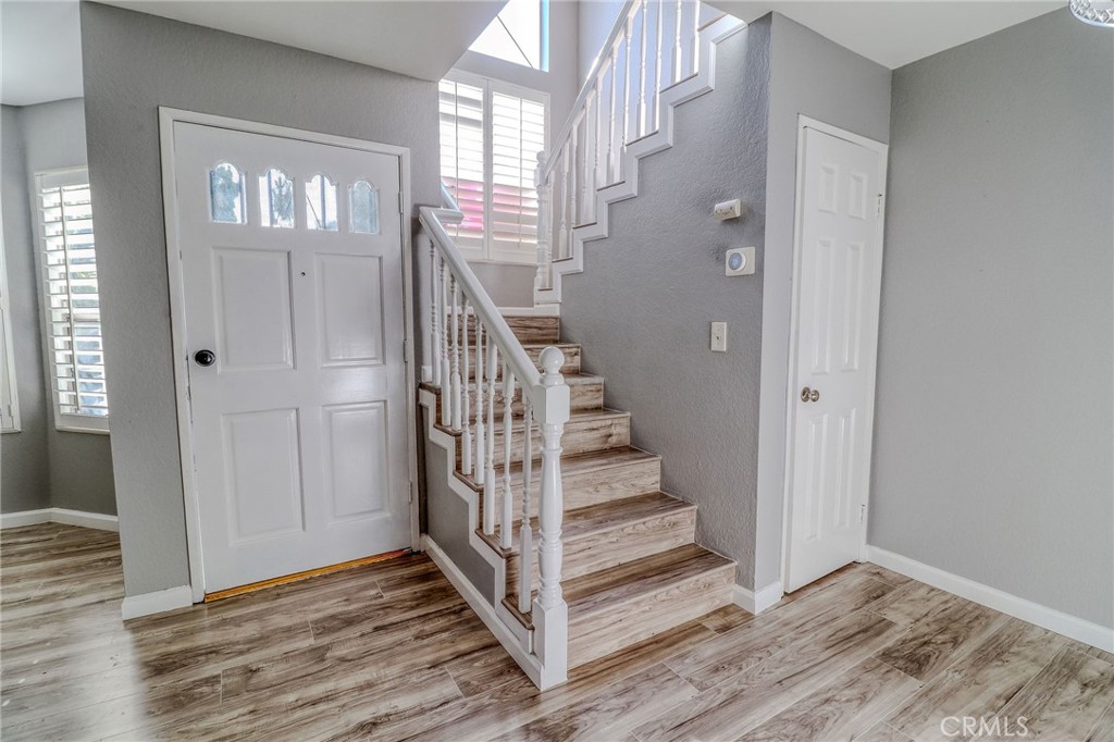 14738 Pioneer Boulevard Norwalk, CA 90650 - Photo 54 of 72 a view of a hallway with wooden floor and entryway