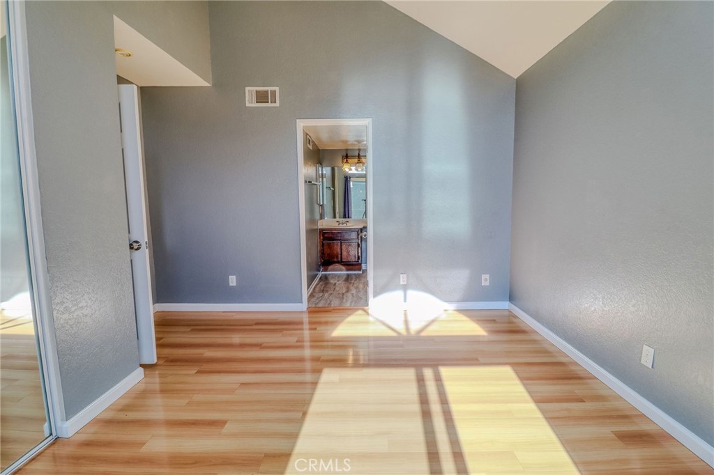 14738 Pioneer Boulevard Norwalk, CA 90650 - Photo 58 of 72 a view of a bedroom with wooden floor and bench