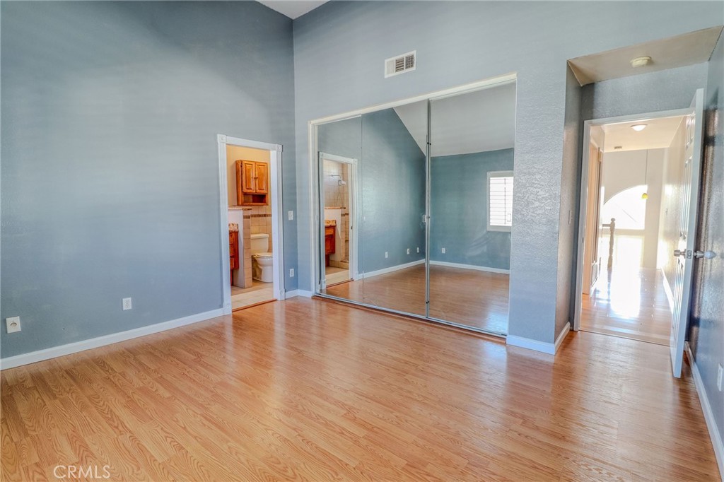 14738 Pioneer Boulevard Norwalk, CA 90650 - Photo 65 of 72 a view of a hallway with wooden floor and a bathroom