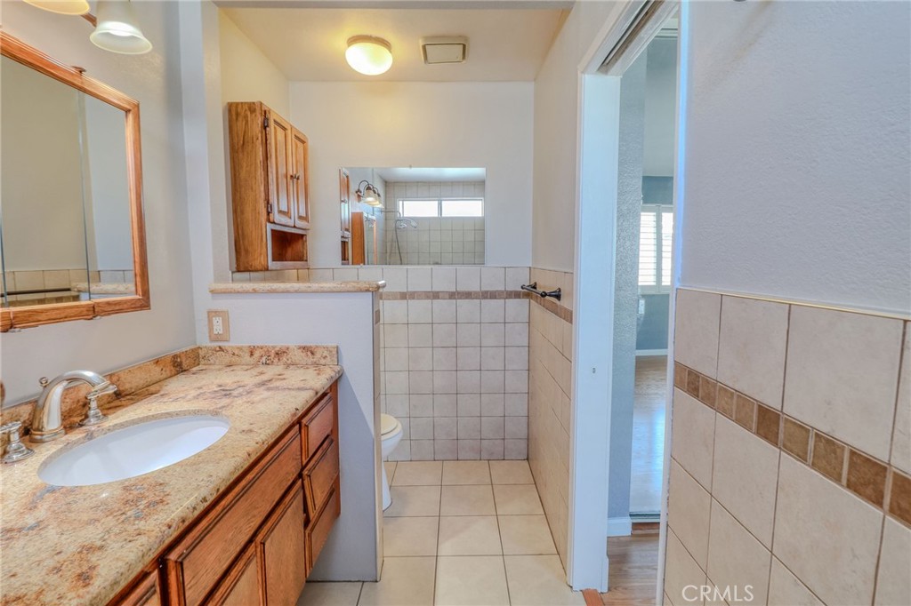 14738 Pioneer Boulevard Norwalk, CA 90650 - Photo 71 of 72 a bathroom with a sink a vanity and a mirror