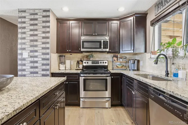 a kitchen with a sink stove and microwave