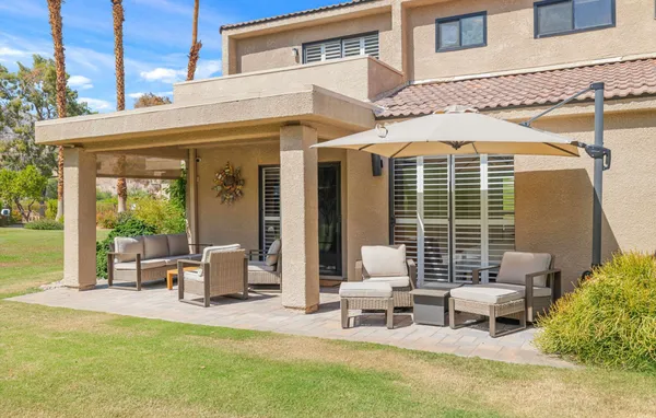 a view of a patio with table and chairs and potted plants
