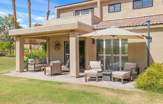 a view of a patio with table and chairs and potted plants